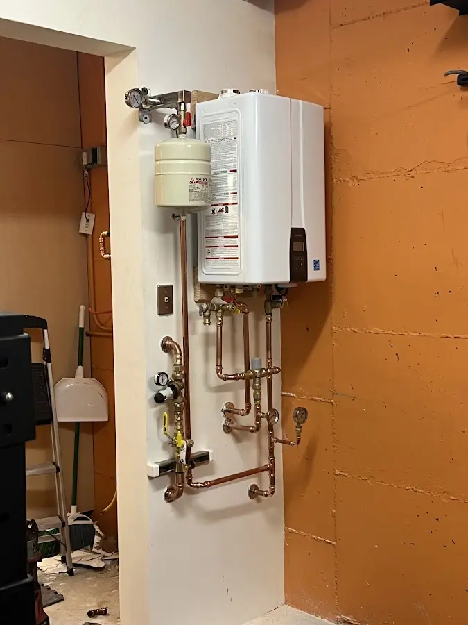 Plumbing technician inspecting water heater connections in Foster City